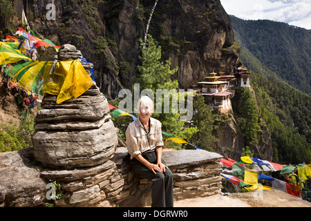 Bhutan, Paro valley, older female tourist at Taktsang Lhakang (Tiger's Nest) monastery Stock Photo