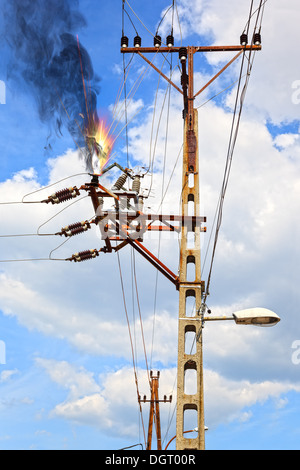 Power pylon - overloaded electrical circuit causing electrical short. Stock Photo