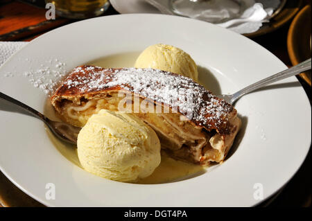 Apple strudel served with vanilla ice cream on a white plate, Nuremberg, Middle Franconia, Bavaria Stock Photo