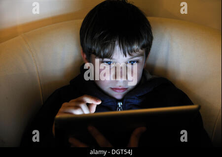 Boy, 8, using an iPad, Ringsheim, Baden-Wuerttemberg Stock Photo