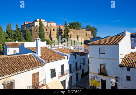 Defensive walls of the old city  viewed over historic buildings near Puerta de Carlos V, Ronda, Spain Stock Photo