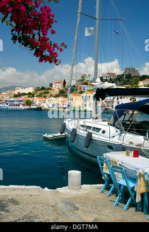 Restaurant terrace with sailing boat, town Megisti on Kastelorizo island, Meis, Dodecanese Islands, Aegean, Mediterranean Stock Photo