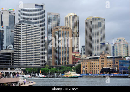 Circular Quay Ferry Wharf, Sydney Cove, Sydney Harbour, city centre at the rear with high-rise office buildings in the Central Stock Photo
