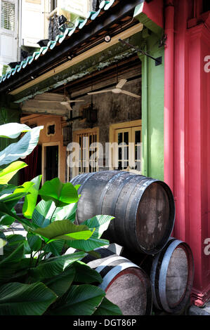 Wooden wine barrels in front of the Que Pasa bar, restaurant in an old house, Emerald Hill Road, Central Area Stock Photo