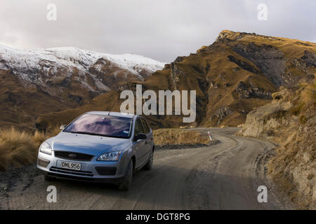 Car on a gravel road in Skippers Canyon, Queenstown, South Island, New Zealand Stock Photo