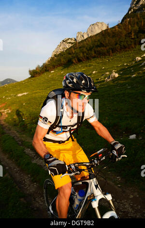 Mountain biker on Kampenwand Mountain, Chiemgau, Upper Bavaria, Bavaria Stock Photo