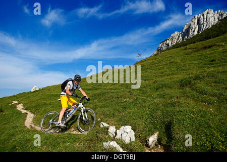 Mountain biker on Kampenwand Mountain, Chiemgau, Upper Bavaria, Bavaria Stock Photo