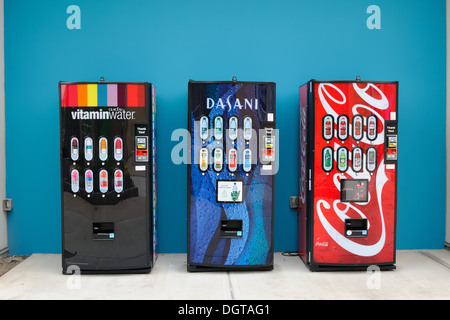 Three vending machines against a blue wall. Stock Photo