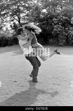 Carefree young couple in a meadow, Leipzig, East Germany, historical photograph around 1974 Stock Photo