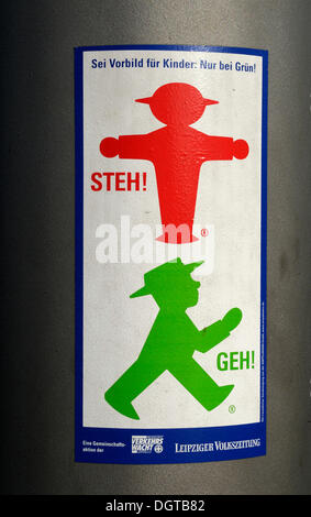Sticker about road safety on traffic lights Stock Photo