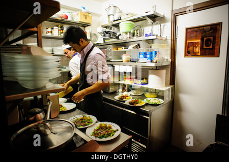 People working in a small professional kitchen, La Mascareta restaurant, Venice, Italy. Stock Photo