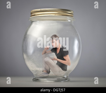 Boy trapped in a glass container Stock Photo