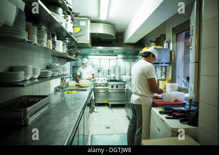 People working in a small professional kitchen, Trattoria da Bepi, Venice, Italy., Venice, Italy. Stock Photo