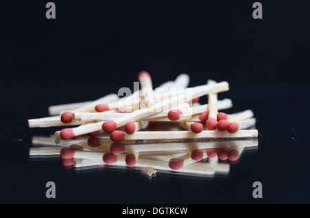A pile of matches on a black background Stock Photo