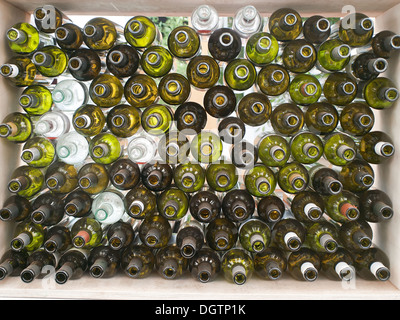 stack of assorted empty wine bottles Stock Photo