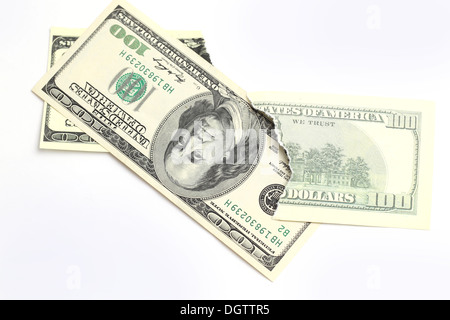 hundred dollars bills. One note is torn apart Stock Photo