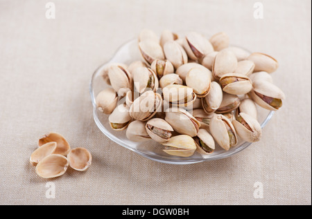 pistachio nuts in shell lying on glass plate Stock Photo