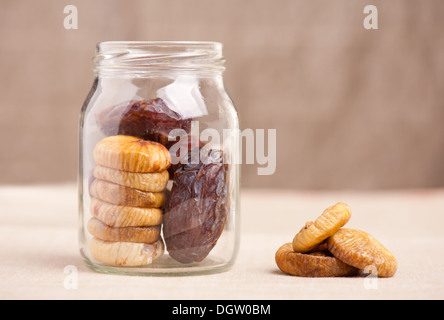 Dried dates and figs in glass jar Stock Photo
