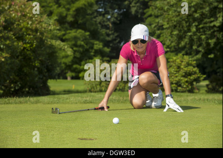 kneeling golfer Stock Photo