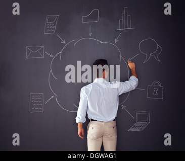 Businessman writing a cloud computing diagram on the chalkboard Stock Photo