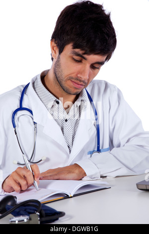 young doctor working at his desk (isolated on white) Stock Photo