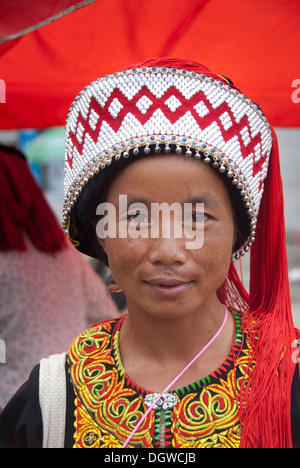 Woman of the Yi or Hani ethnic minority wearing colourful headware at a festival, portrait, Jiangcheng, Pu'er City
