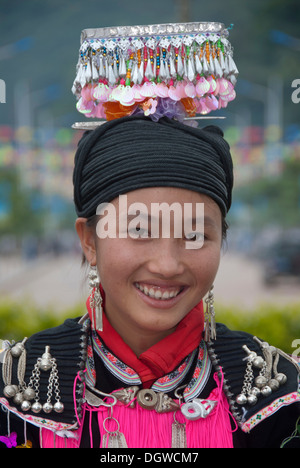 Ethnic festival, portrait, young woman of the Yao minority in traditional costume with headdress smiling, Jiangcheng, Pu'er City Stock Photo