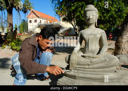 Theravada Buddhism, stonemason, working on a delicate detail, fingers, hands of a Buddha statue, Wat Xayaphoum temple Stock Photo