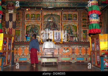 Tibetan Buddhism, novice standing in front of the altar, Yung Drung Kundrak Lingbon Monastery, Bon Sect, near Ravangla, Sikkim Stock Photo
