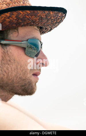 Closeup of young unshaved man in hat and sunglasses. Stock Photo