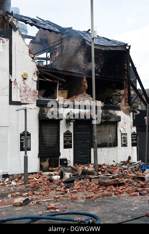 Gas Explosion and fire at Pub Public house walls demolished bricks strewn blown across road Stock Photo