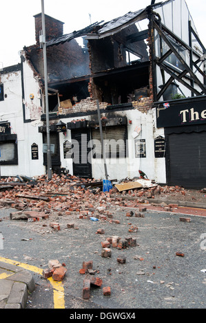 Gas Explosion and fire at Pub Public house walls demolished bricks strewn blown across road Stock Photo