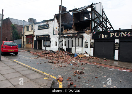 Gas Explosion and fire at Pub Public house walls demolished bricks strewn blown across road Stock Photo