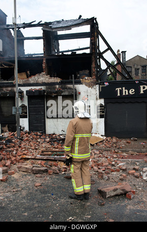 Gas Explosion and fire at Pub Public house walls demolished bricks strewn blown across road Stock Photo