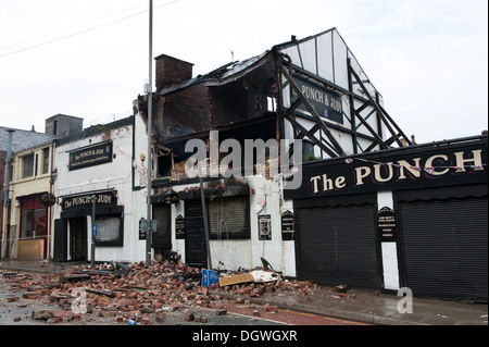 Gas Explosion and fire at Pub Public house walls demolished bricks strewn blown across road Stock Photo