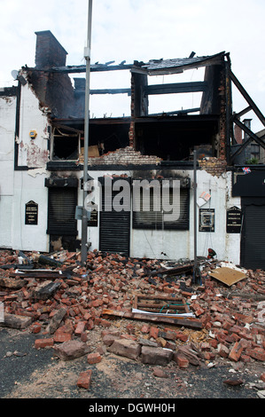 Gas Explosion and fire at Pub Public house walls demolished bricks strewn blown across road Stock Photo