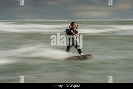 kitesurfer riding waves, panning shoot Stock Photo