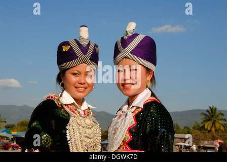 Portrait of smiling young women of the Hmong ethnic group in traditional costume, traditional dress, hat, cap, Vang Vieng, Laos Stock Photo