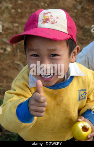 View from above, poverty, OK sign, thumbs up, grinning boy having fun, village of Ban Komaen, Phongsali district and province Stock Photo