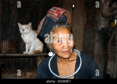 Portrait of an old woman of the Akha Pala ethnicity, traditional clothing dyed with indigo, colorfully embroidered turban Stock Photo