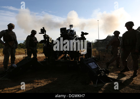 U.S. Marines with Echo Battery, 2nd Battalion, 10th Marines, fire a high explosive round from an M777 Howitzer during Operation Stock Photo