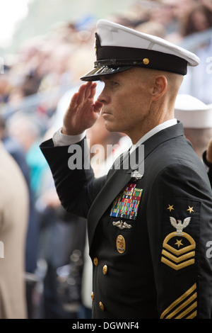 A U.S. Navy Master Chief Petty Officer salutes during the national anthem at the 30th anniversary of the Beirut bombing in Jacksonville, N.C., Oct. 23, 2013. The city of Jacksonville holds a ceremony every year in honor and remembrance of those affected b Stock Photo