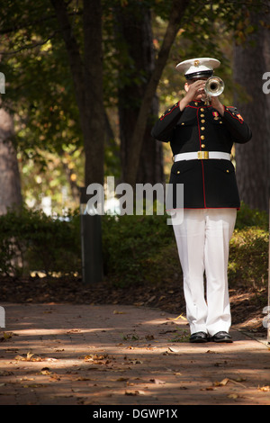 A member of the 2D Marine Division band plays Taps during the 30th anniversary memorial ceremony of the Beirut bombing in Jacksonville, N.C., Oct. 23, 2013. The city of Jacksonville holds a ceremony every year in honor and remembrance of those affected by Stock Photo