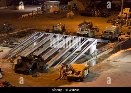 U.S. Marines and Sailors assigned to the 26th Marine Expeditionary Unit (MEU) conduct a wash down aboard Naval Station Rota, Spain, Oct. 20, 2013. The 26th MEU is a Marine Air-Ground Task Force forward-deployed to the U.S. 6th Fleet area of responsibility Stock Photo