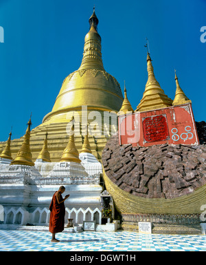 Monk praying in front the Shwemawdaw Paya pagoda, Bagu, Bago Region, Myanmar, Burma Stock Photo