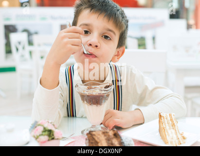 Child eat milk choco shake on a table Stock Photo