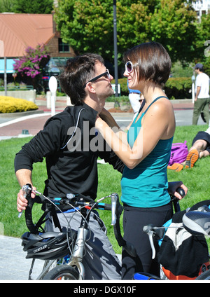 couple on bikes hugging and looking at each other at Tiburon ferry Stock Photo