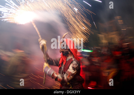 People dance surrounded by fire and pyrotechnics during a traditional fire run in the island of Mallorca, Spain Stock Photo