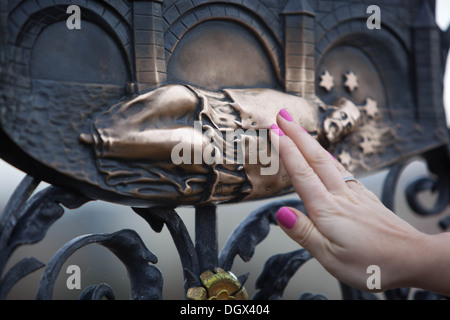 The iron grille with a relief, where according to legend was thrown into the river St John of Nepomuk Charles Bridge Prague close up Stock Photo