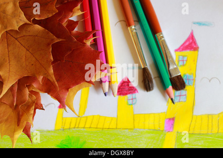 Children's drawing of house and yellow autumn leaves Stock Photo